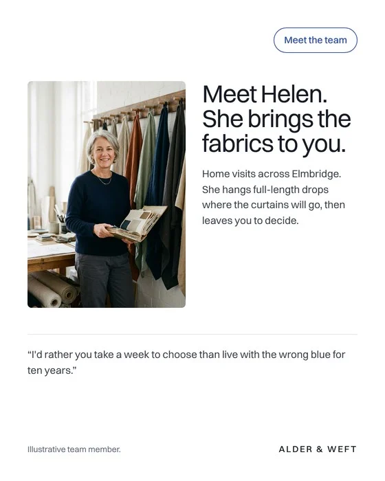 Meet the team: Helen, the designer, beside hanging fabrics