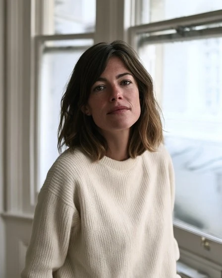 Claire by a sash window in her renovated home